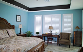 Custom shutters in a bedroom